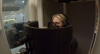 Emily in Mike's studio recording the song, shown on LPTV