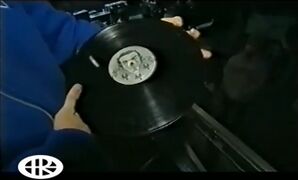 Joe showing the vinyl on the "Hybrid Odyssey" documentary
